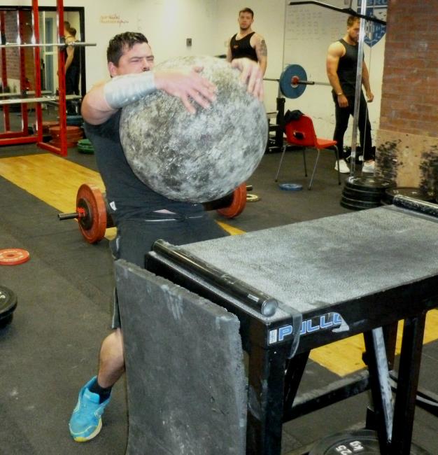 Rory Brown lifts a heavy bolder